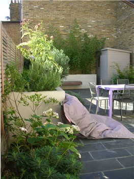 small garden that makes the best use of space with a cantilevered bench and raised beds